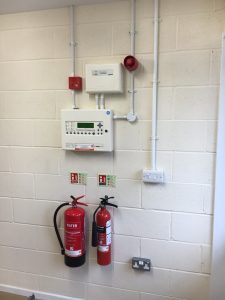 Fire alarm panel, sounder, and fire extinguisher in new Scout centre